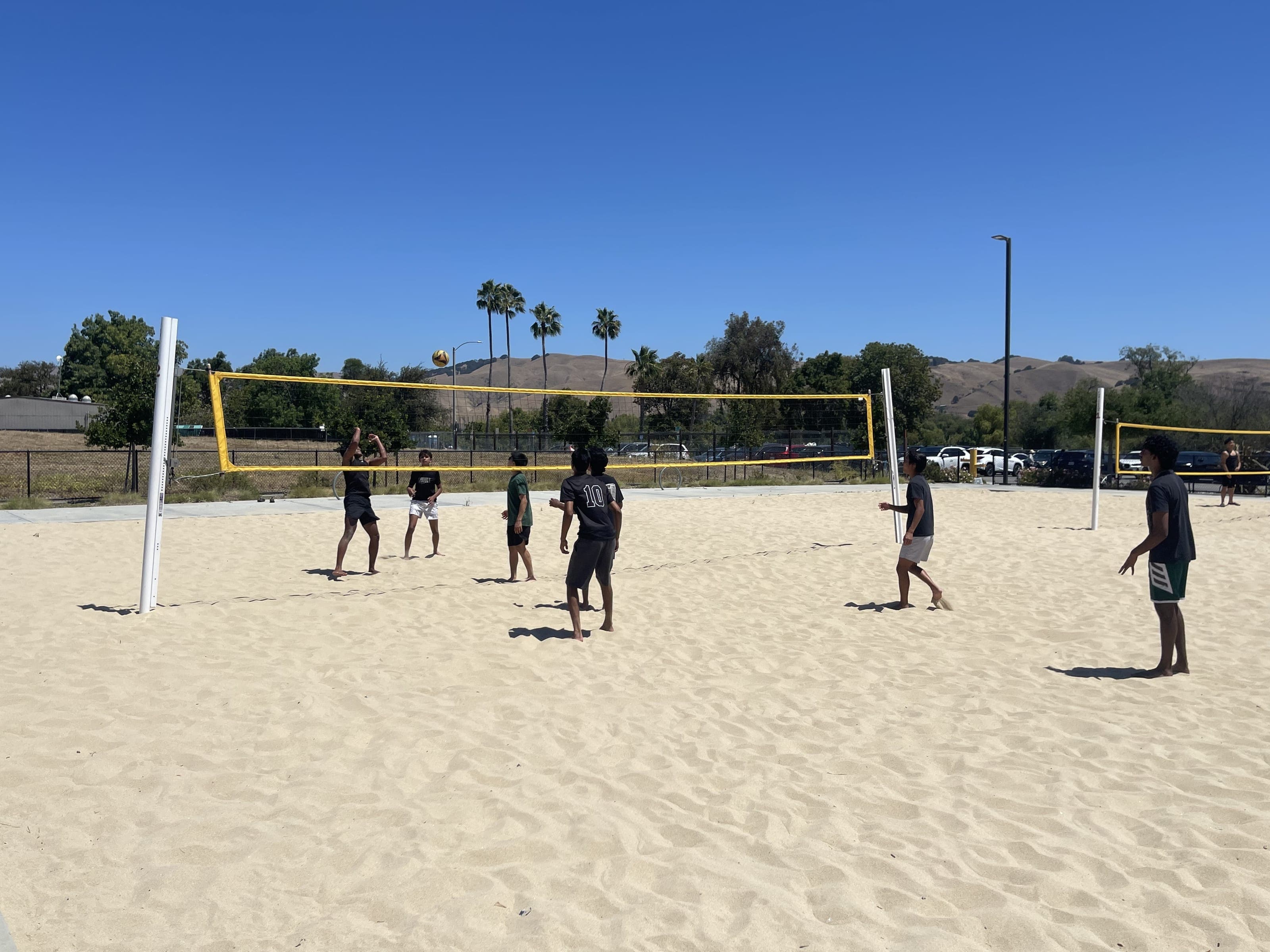 A pickup volleyball game on the sand courts at a Fremont park